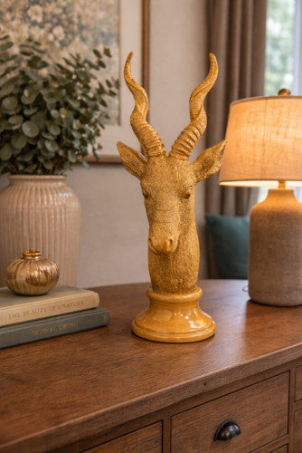 Golden gazelle head tabletop sculpture with curved horns